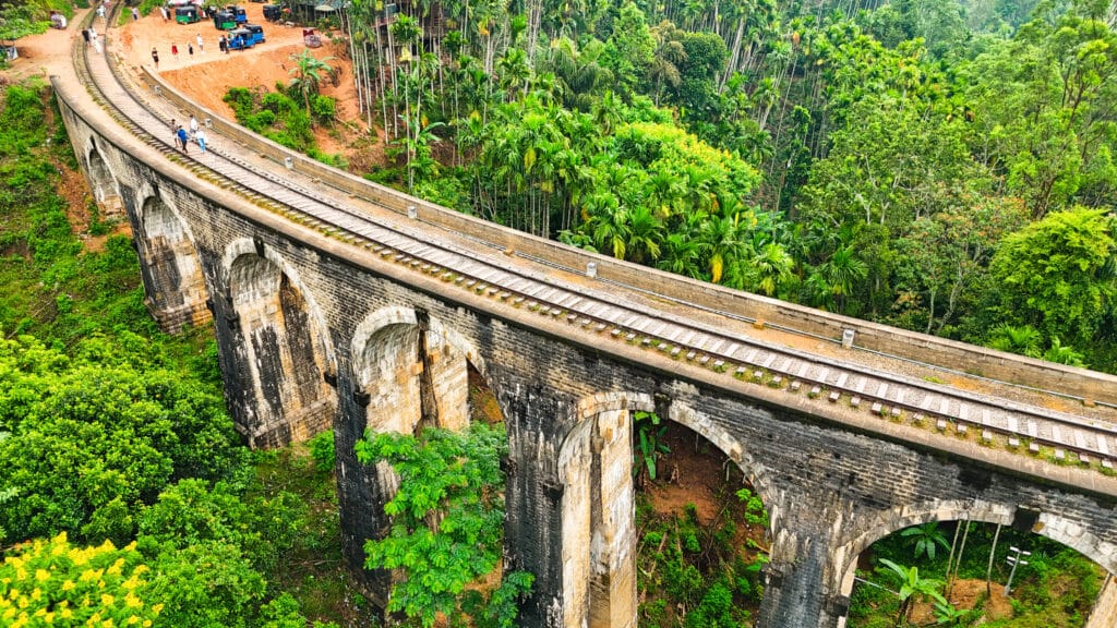 Aerial view of the Nine Arch Bridge surrounded by lush jungle in Ella, Sri Lanka