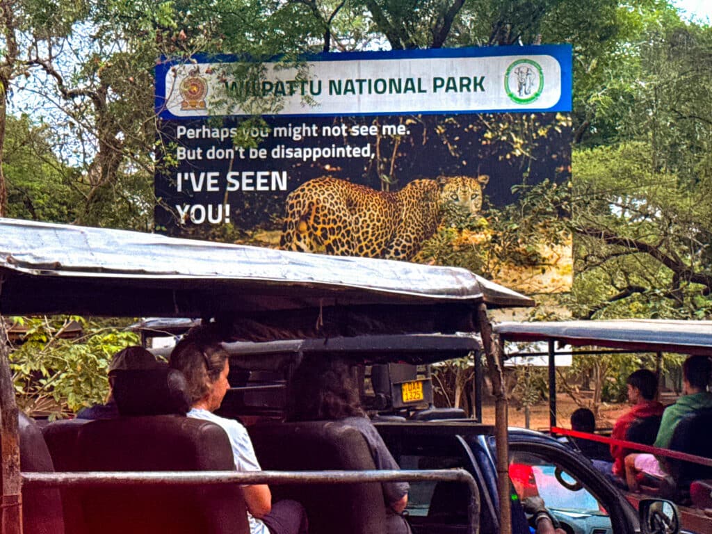 Safari jeep near the entrance sign of Wilpattu National Park in Sri Lanka