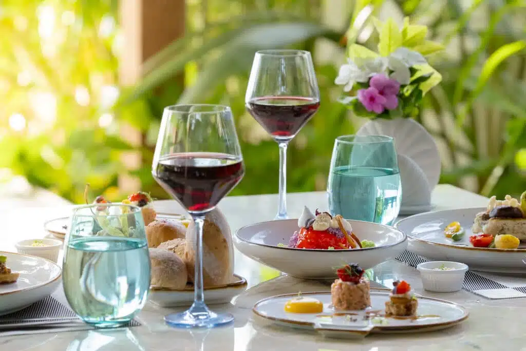 Isole locali delle Maldive vs Resort: cosa dovresti scegliere? 7 elegante pranzo al resort con vino rosso e piatti serviti all'Atmosphere Kanifushi Maldives