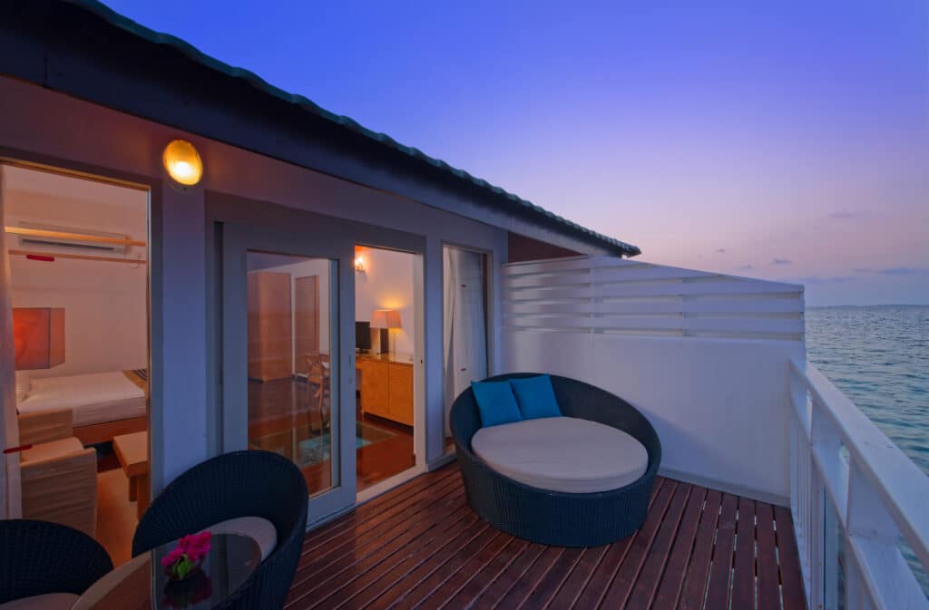 How to Choose a Maldives Resort: The Complete Decision Guide 2 overwater bungalow balcony at Embudu Village Maldives at dusk with ocean view