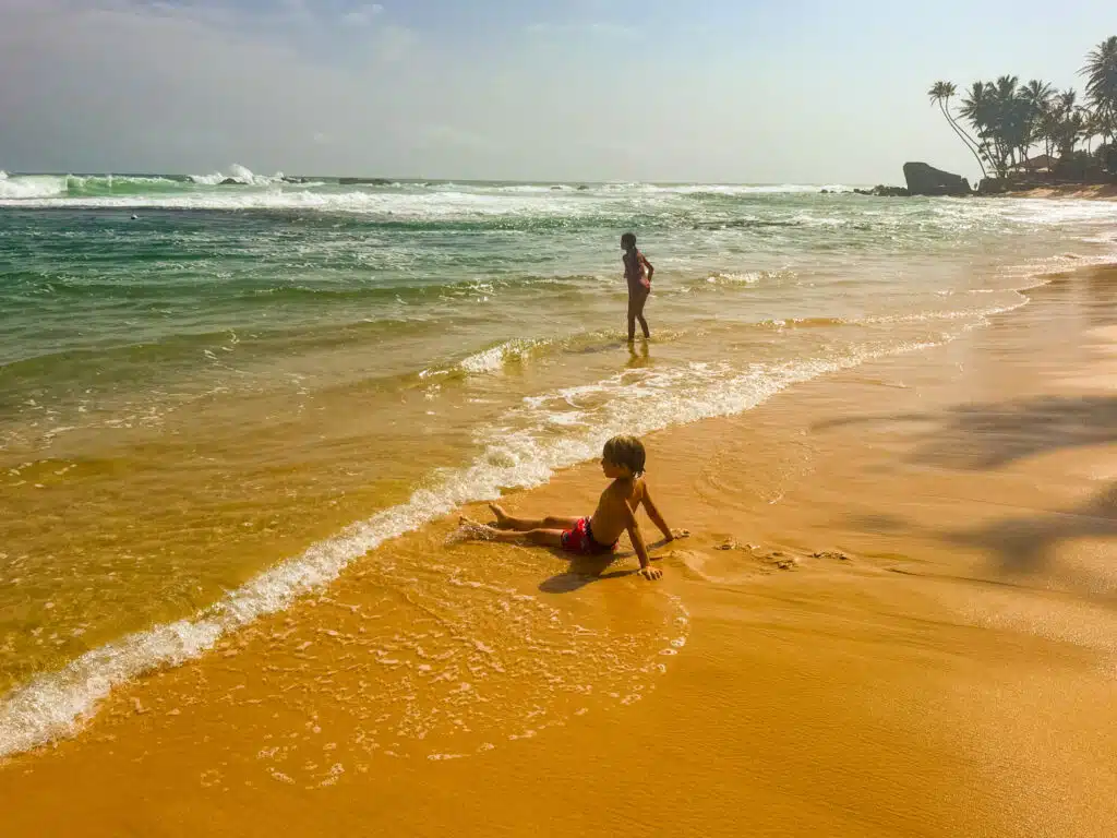 Sri Lanka South Coast: Beaches, Surf Towns & Coastal Travel 1 wide sandy beach along the Sri Lanka South Coast with turquoise water and blue sky