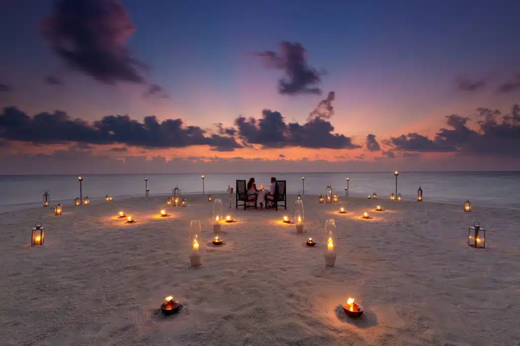 How to Choose a Maldives Resort: The Complete Decision Guide 7 romantic candlelit beach dinner for two at Baros Maldives at sunset with lanterns on white sand