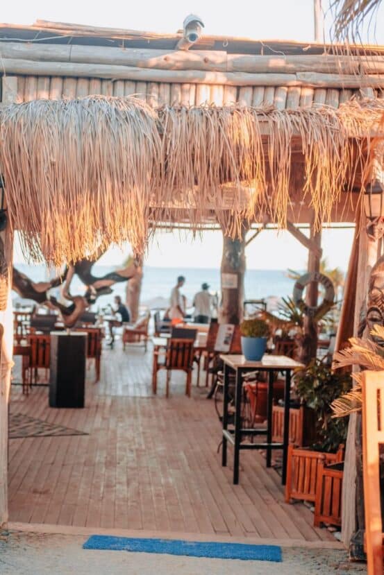 Gulhi Maldives: Affordable Local Island Close to Malé 11 restaurant dining area with wooden tables, chairs and decorative hanging strands on Gulhi