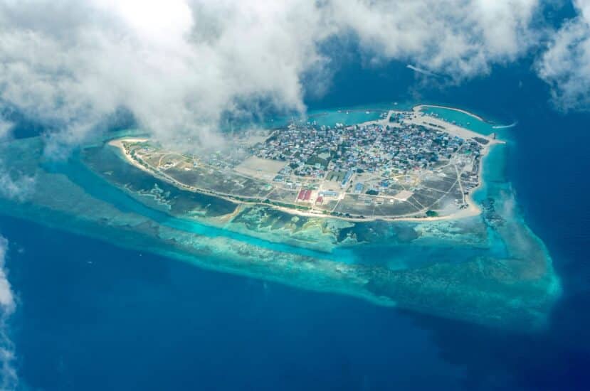 Maafushi Maldives: The Complete Budget Travel Guide to the Most Popular Local Island 1 aerial view of the densely built local island of Maafushi ringed by reef and turquoise lagoon