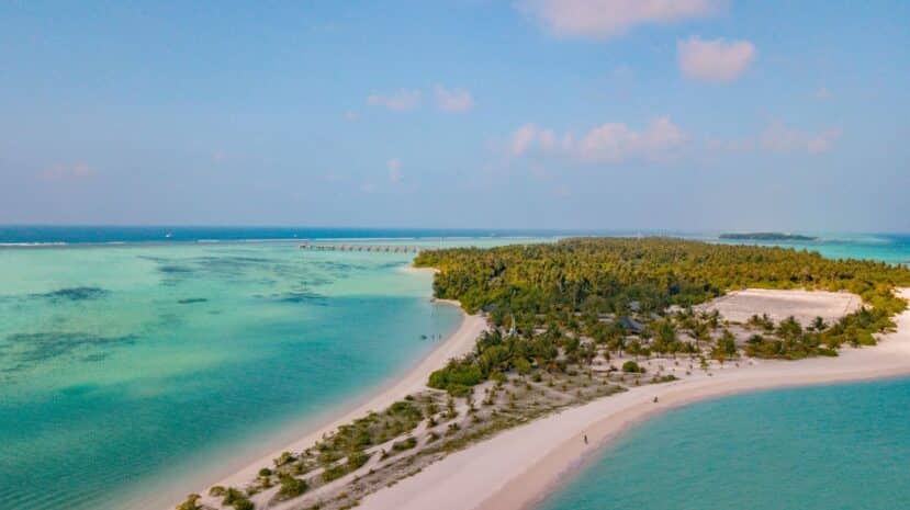Dhigurah Maldives: The Best Local Island for Whale Shark Encounters 2 aerial view of the long narrow green island and white sandbank of Dhigurah surrounded by turquoise water