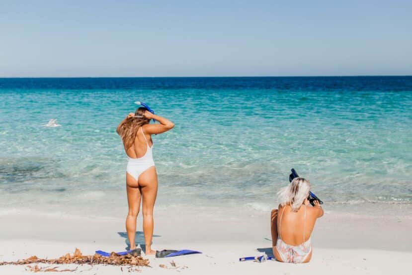 Ukulhas Maldives: The Best Local Island for Snorkelling, Clean Beaches & Island Life 1 person with snorkelling gear on a white sand beach beside a turquoise lagoon on Ukulhas