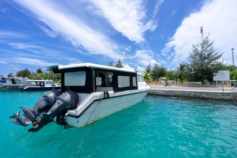 Ukulhas Maldives: The Best Local Island for Snorkelling, Clean Beaches & Island Life 11 white speedboat moored at a jetty in turquoise water beside a local island