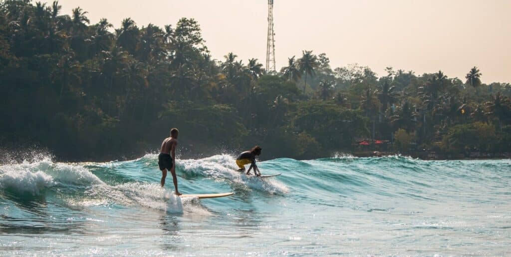 Sri Lanka South Coast: Beaches, Surf Towns & Coastal Travel 16 surfers riding waves in the horseshoe bay at Hiriketiya on Sri Lanka south coast