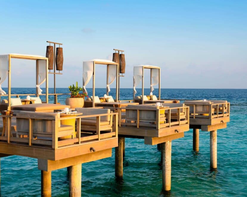 Baa Atoll Maldives: The Complete Guide to Baa and Raa Atoll 9 Vakkaru Maldives Baa Atoll lagoon bar at sunset with overwater villas and orange sky