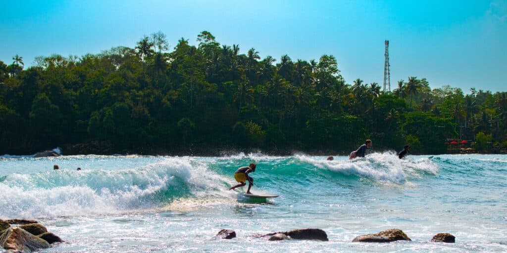 Best Beaches in Sri Lanka: A Guide by Coast & Season 5 Hiriketiya horseshoe bay turquoise water surrounded by green hills south coast Sri Lanka