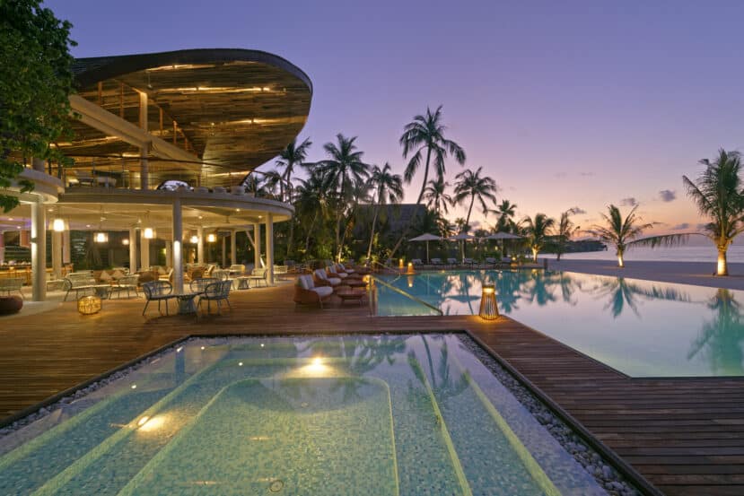 North and South Ari Atoll Guide (Alif Alif & Alif Dhaal): Resorts, Local Islands & Everything You Need to Know 13 Outrigger Maldives Maafushivaru South Ari Atoll resort pool at night with villa lights